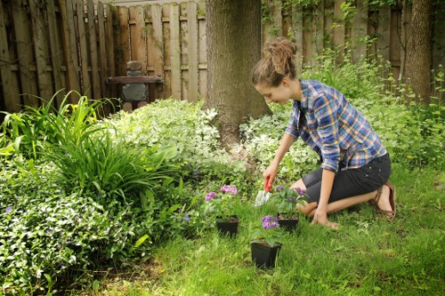 Workers wearing PPE including gloves, goggles and hearing protection while mowing